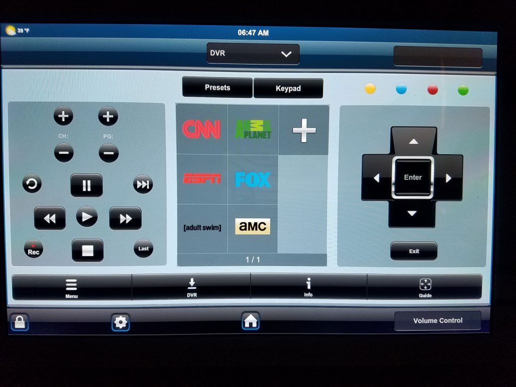 A touchscreen remote control interface displays DVR options, channel buttons for CNN, Animal Planet, ESPN, FOX, Adult Swim, and AMC, along with navigation arrows, volume, and record/playback controls.